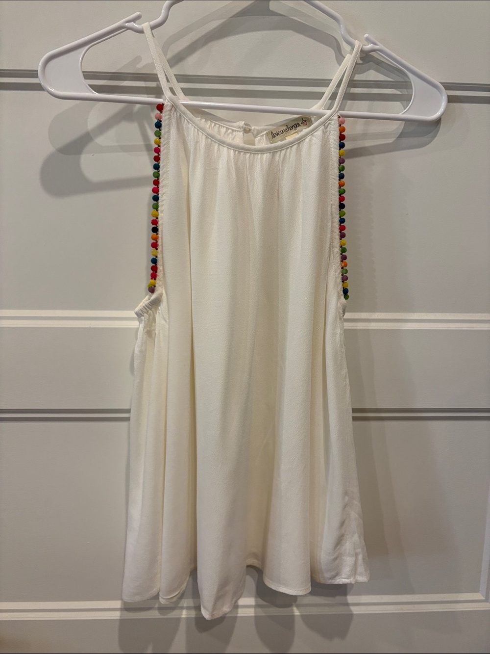 Ivory  Strap Swing Tank with colored Poms from Dillards love on a hanger